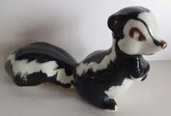 Black and white ceramic skunk figurine.