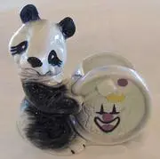 Ceramic panda figurine holding a plate.