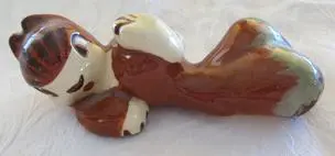 Ceramic figurine of a sleeping dog.