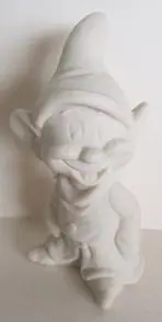 White ceramic figurine of a smiling elf.