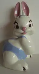 White porcelain bunny figurine with blue bow.