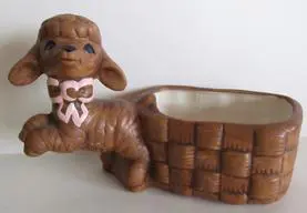 Ceramic lamb planter with a basket.