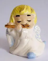 A porcelain angel playing a flute.