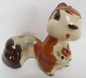 Ceramic squirrel figurine with brown and green glaze.