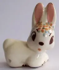 Ceramic bunny figurine with floral details.